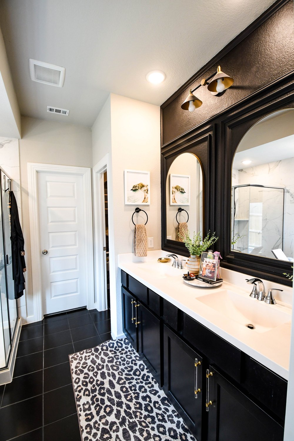 The vanity run with the leopard runner and the water closet door at the end