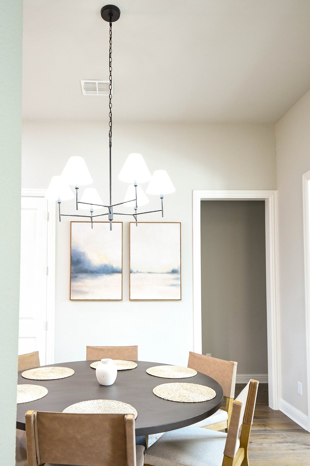 The breakfast table and chandelier framed by the hallway