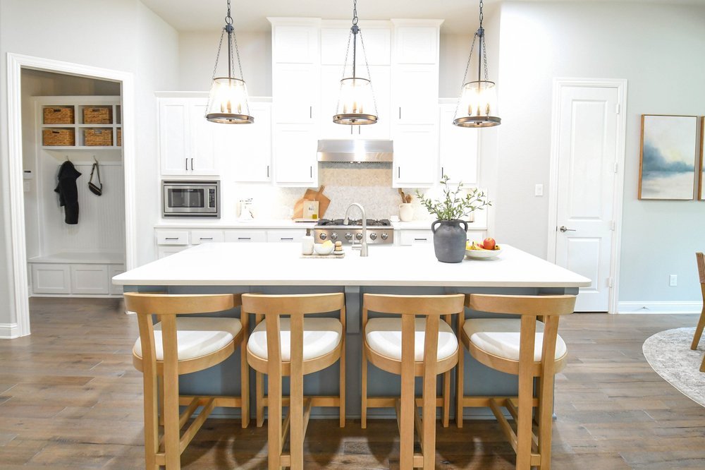 The kitchen and island from the dining room with the drop zone bench beyond