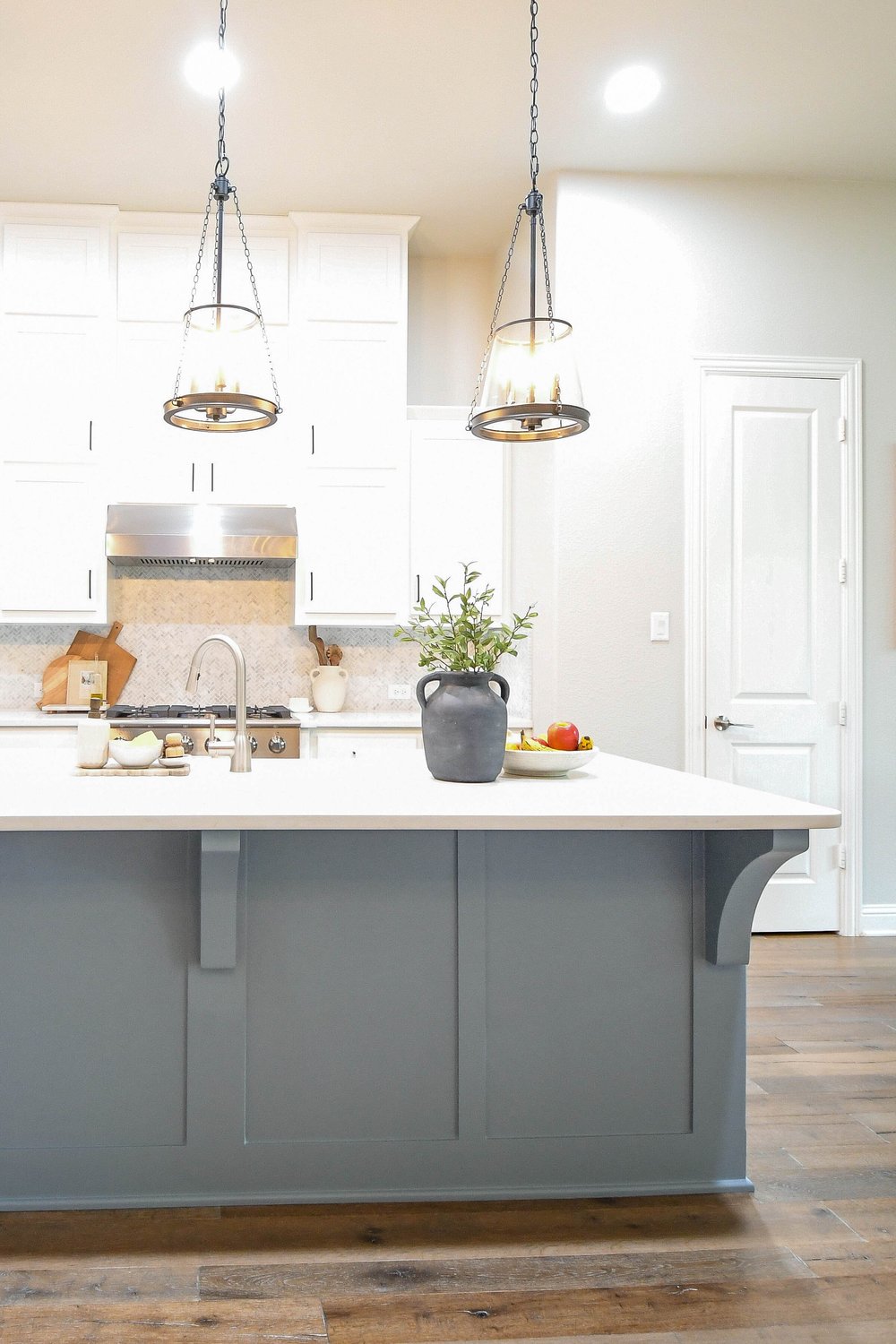 The island's corbelled end and the tile backsplash behind the range