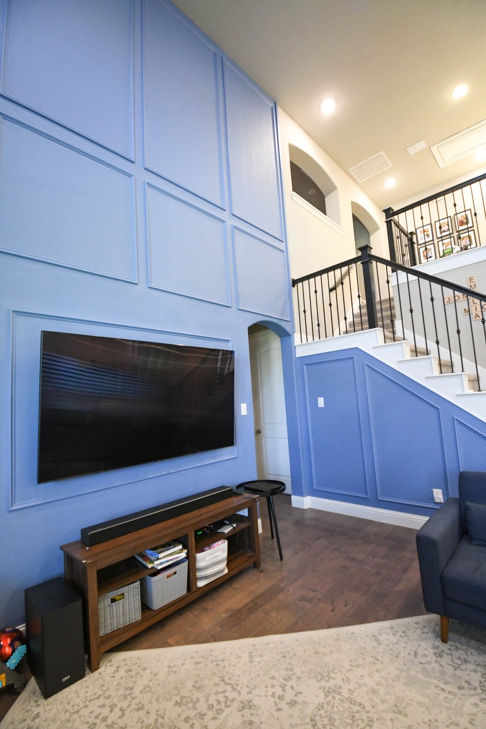 The full height of the blue panelled wall with the TV and console below