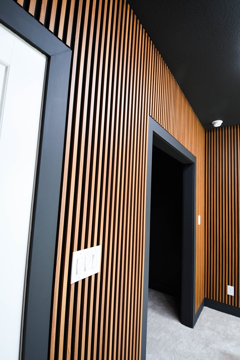 Close view of the wood slat panelling against the black trim