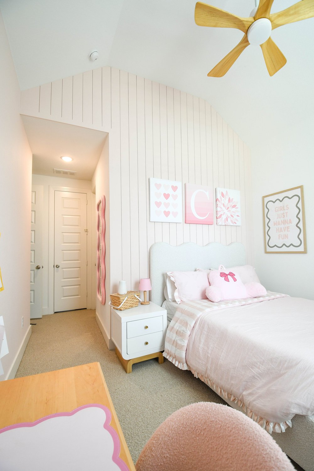 The bed, framed prints and the door to the hall