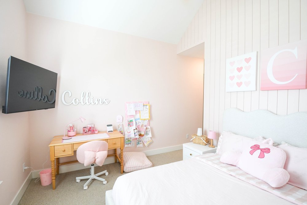 The desk and name sign across from the bed