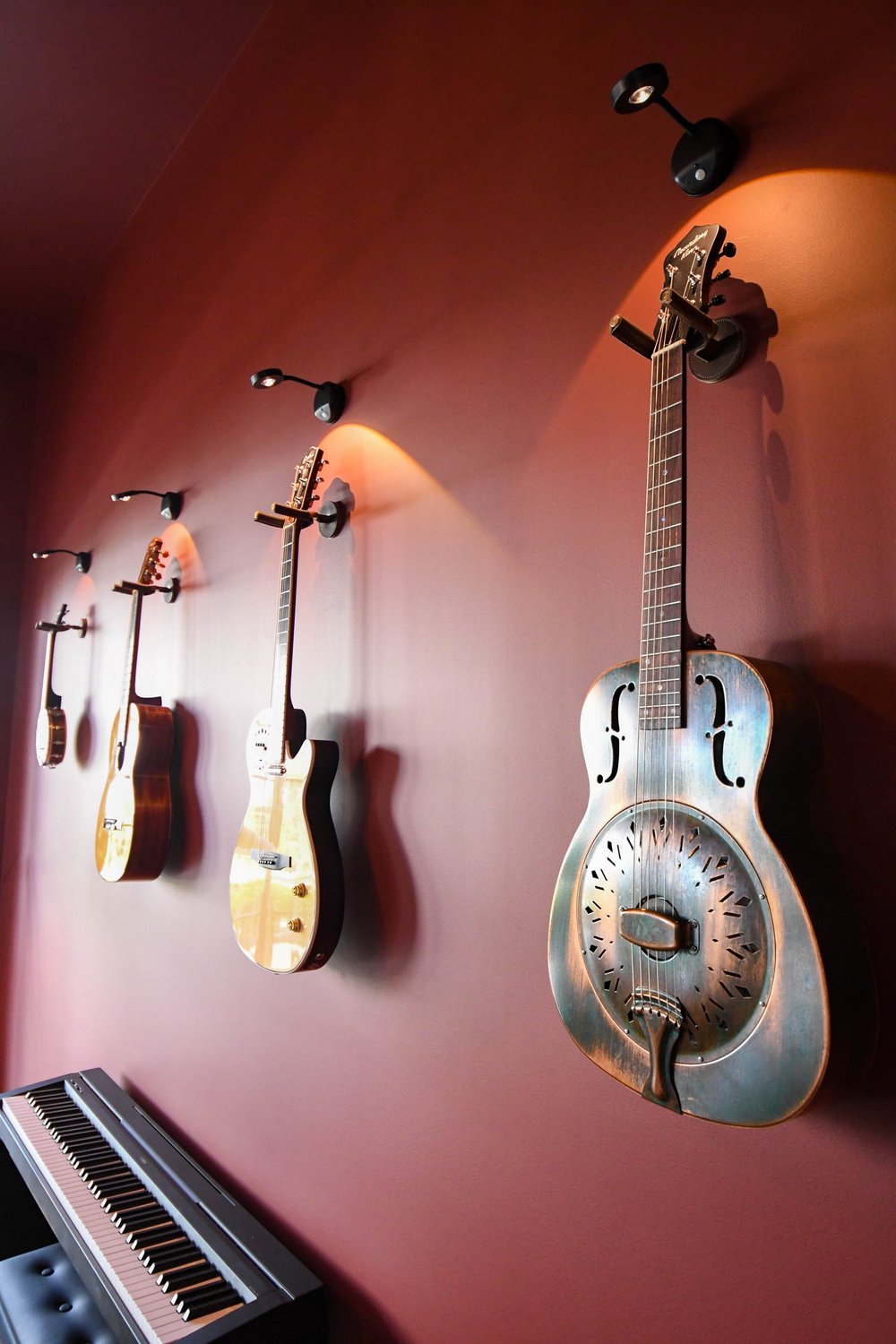 Instrument wall lit by picture lights above the keyboard