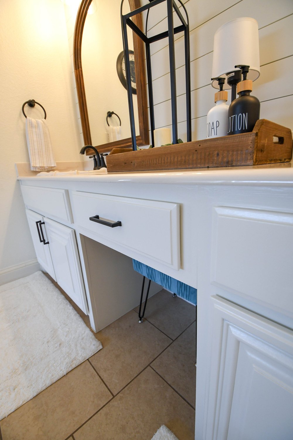 White bathroom vanity with a make-up desk set between the cabinets