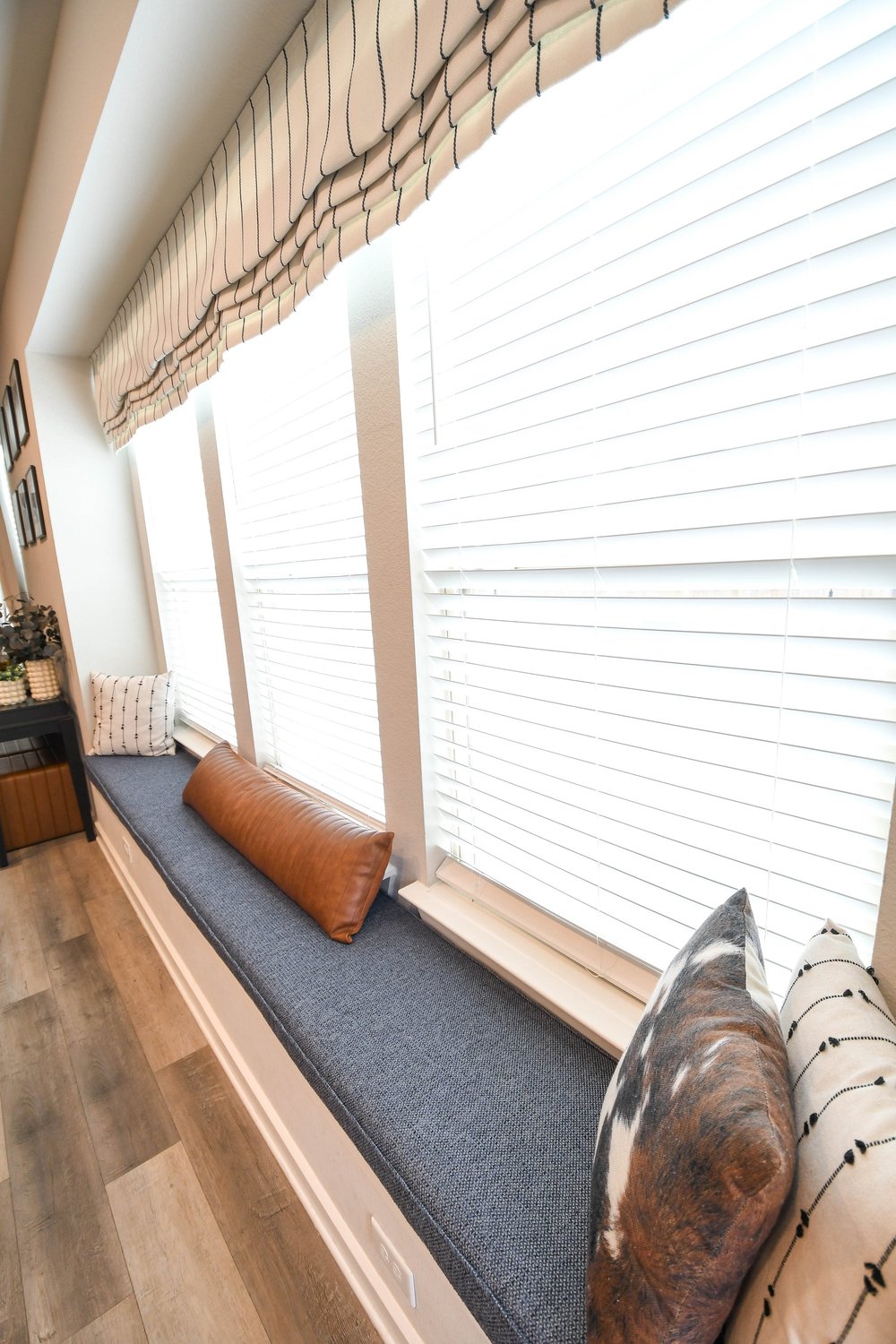 The bench cushion and pillows down the length of the bay window