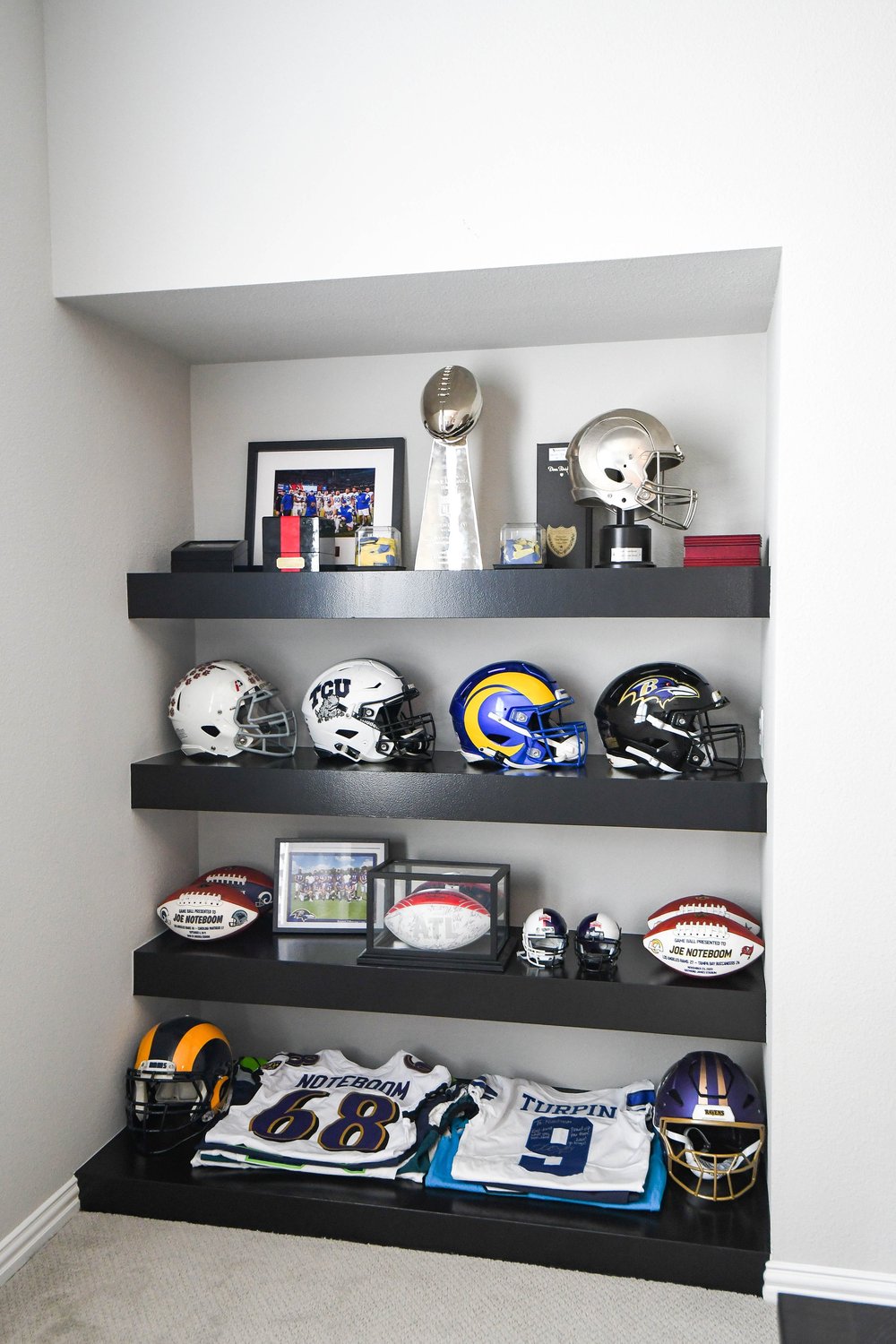 The memorabilia shelves straight on with mini helmets, signed footballs and jerseys