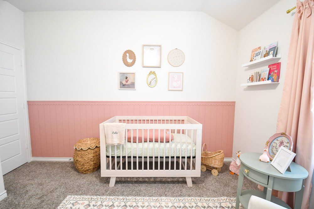 Nursery with the crib, book ledges and blush curtains