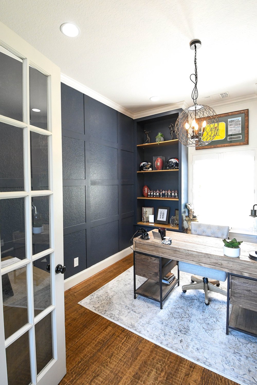 Looking through the French doors at the desk and navy panelled wall