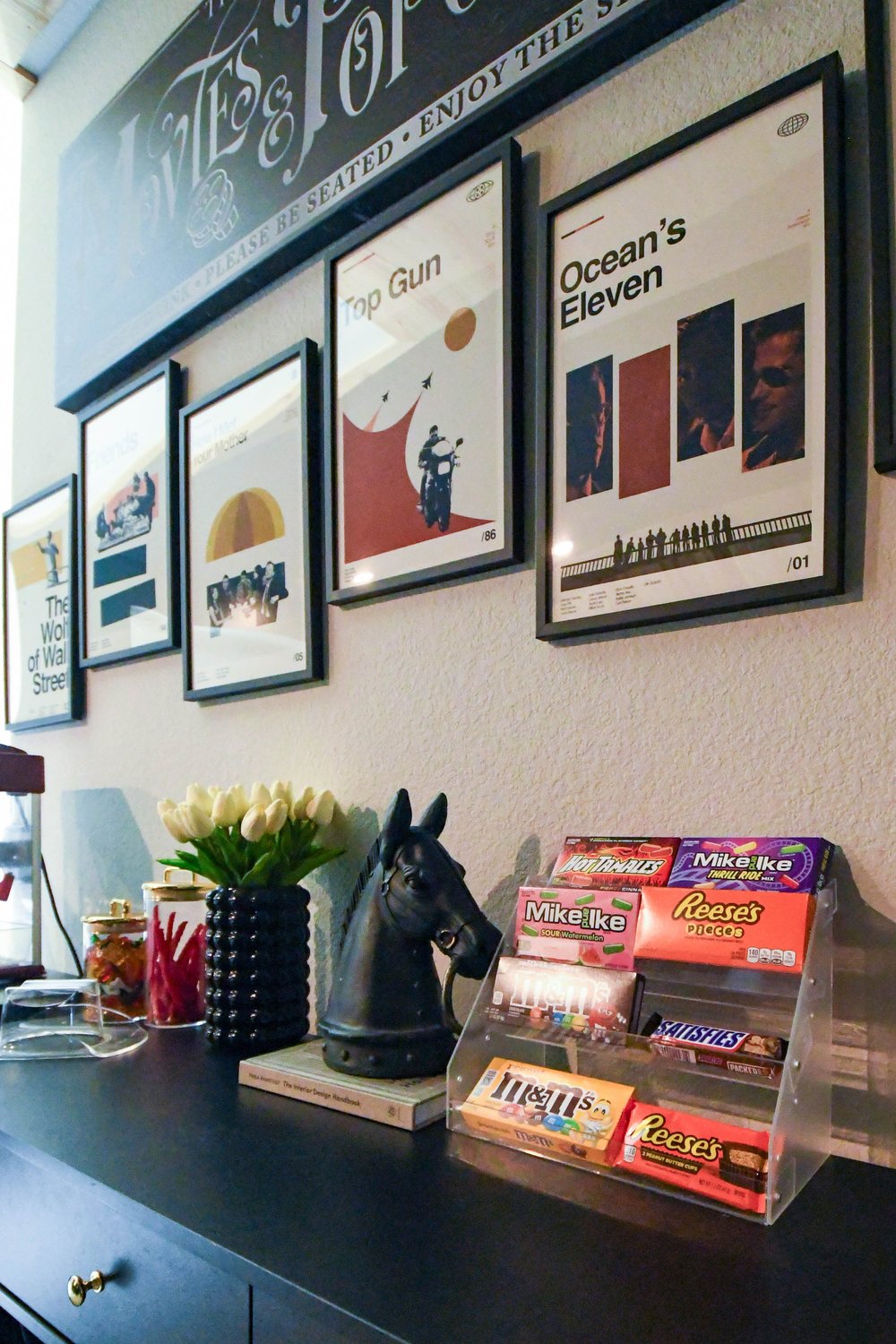 Framed film posters above the concession counter's sweets