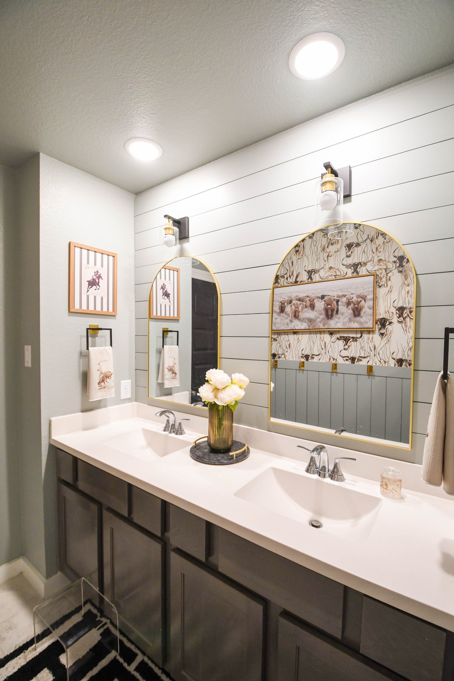 A bathroom with floor-to-ceiling tile, a frameless glass shower and a stone-topped vanity